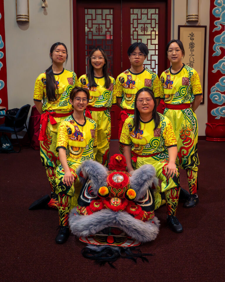 Edmonton KSK team A members posing with their grey and red Chinese lion.