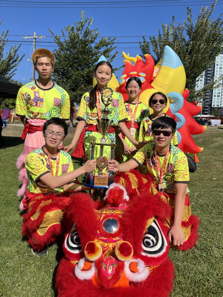 KSK team memberes posing with their 3rd place trophy and red Chinese lion at the Canada National Lion Dance Championship 2025.