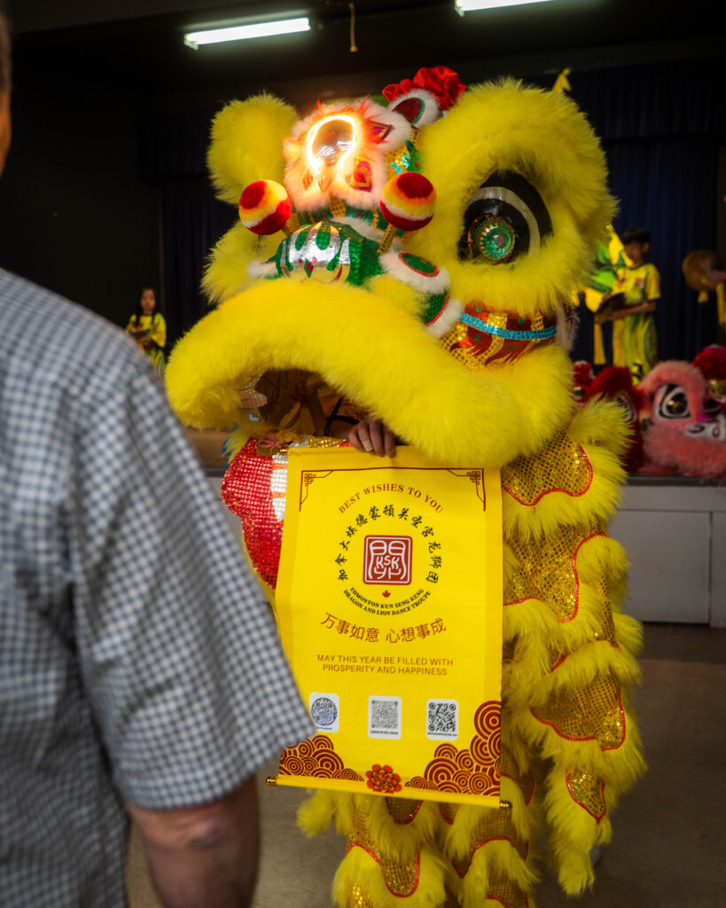 Yellow lion presenting a best wishes banner