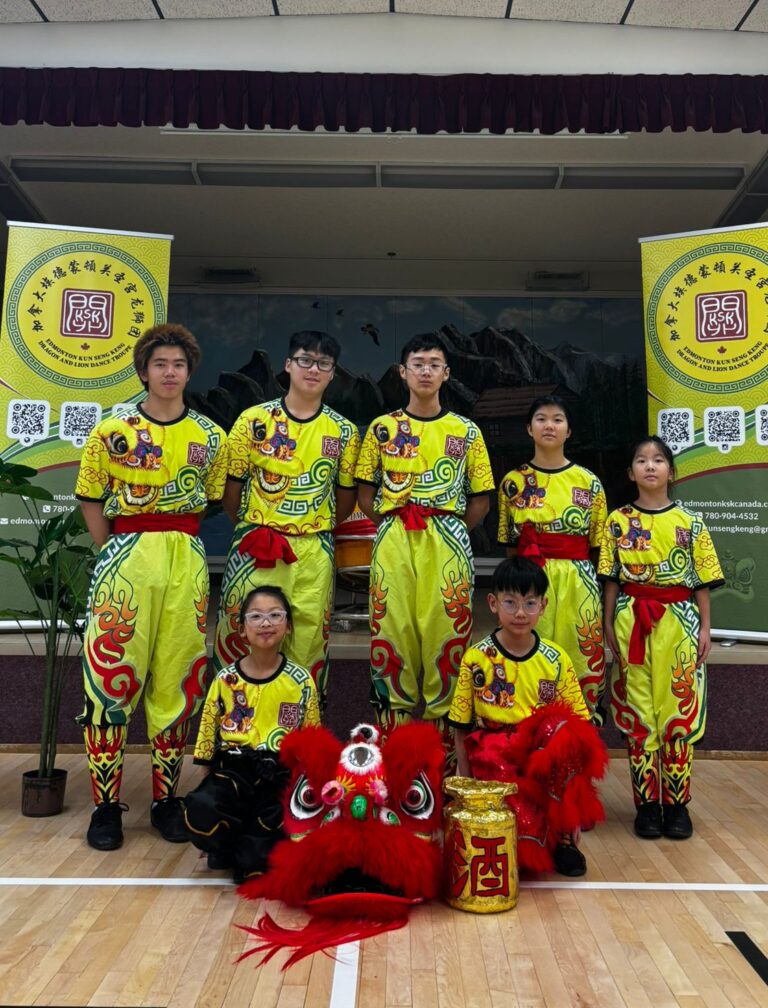 Photo of 7 members of the KSK Junior team posing with their red Chinese lion