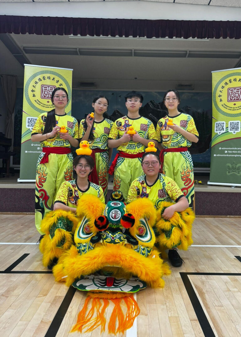 Photo of 6 members of the KSK Senior team A posing with their green and yellow Chinese lion