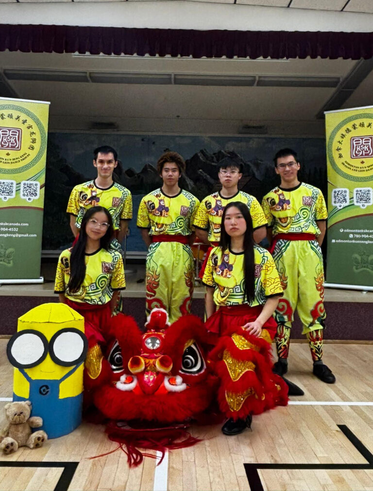 Photo of 6 members of the KSK Senior team C posing with their red Chinese lion and their cardboard minion prop and teddy bear.